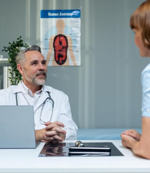 Caucasian senior woman visit and consult health problem with doctor. Mature elderly therapist practitioner working to explain diagnosis and give treatment to sick woman during appointment in hospital.